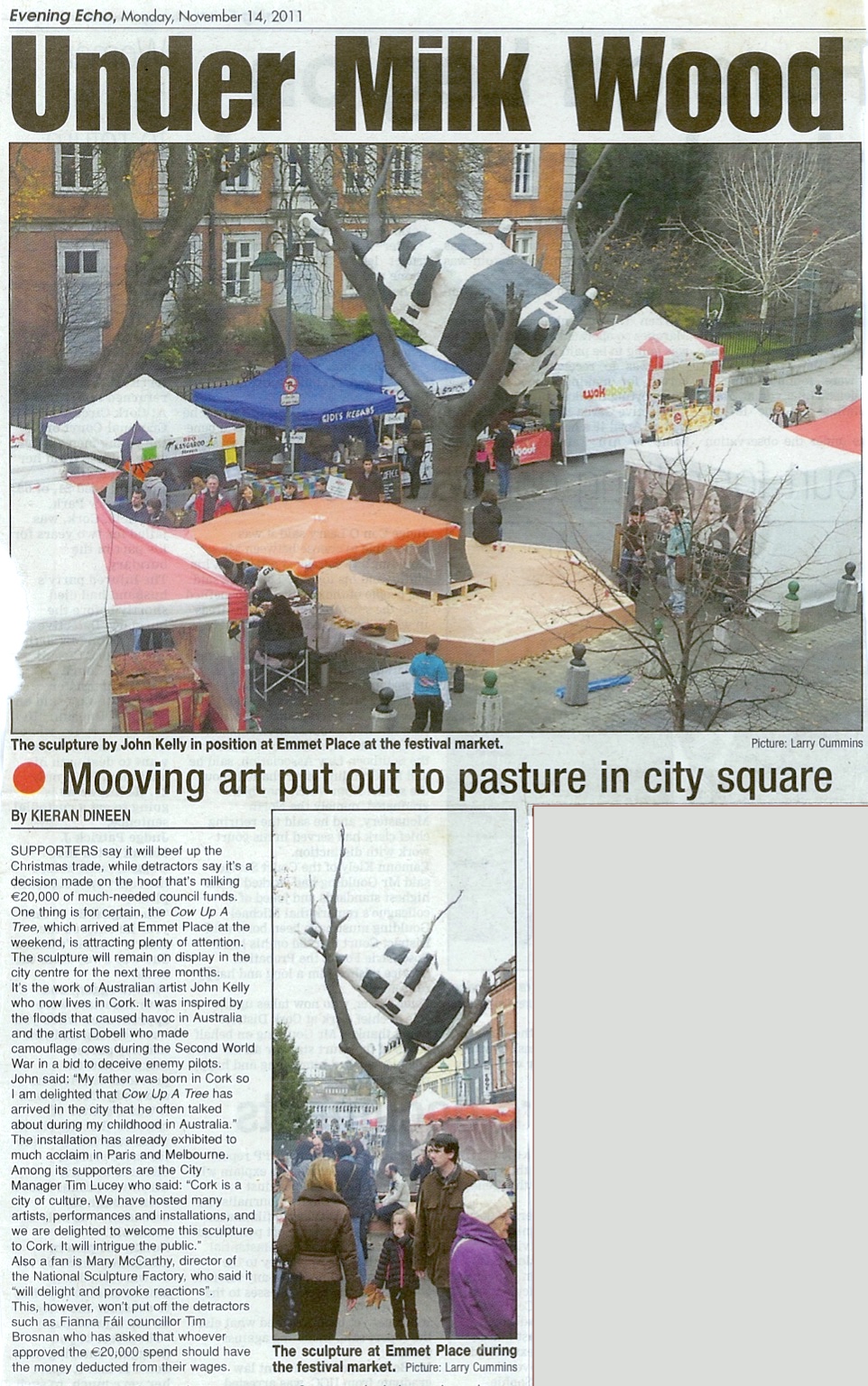 Kieran Dineen, ‘Under Milk Wood’, Evening Echo, 14 November 2011; newspaper article with two imags, the top, larger one showing Cow up a Tree in position outside the Crawford Art Gallery with stalls of various sorts around it; the second shows people milling about near the sculpture